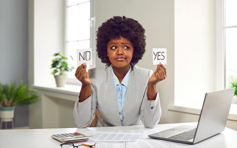 A recruiter holds up two cards, one reading, "no" and one reading, "yes."
