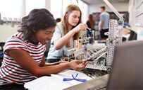 Two women work on an engineering project.