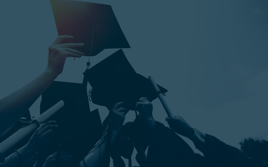Graduates lifting their grad caps.