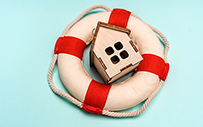 A wooden house sitting inside a life ring.