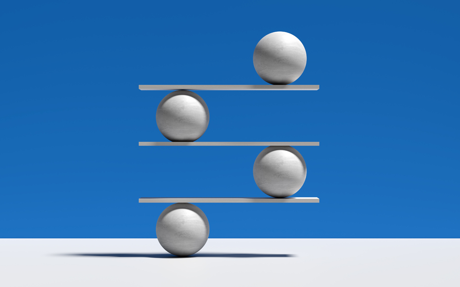 Four rows of stone balls balancing on boards.
