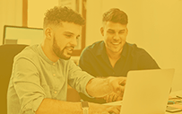 Two employees work together on an AI project.