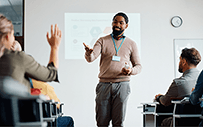 An employer interacts with college students in the classroom.