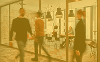 Workers walking through an office.