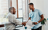 An employer shakes the hand of an intern.